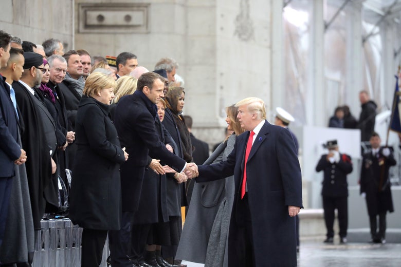 US president Donald Trump shakes hands with French president Emmanuel Macron as he arrives at the Arc de Triomphe in Paris on November 11, 2018 to attend a ceremony as part of commemorations marking the 100th anniversary of the 1918 armistice.